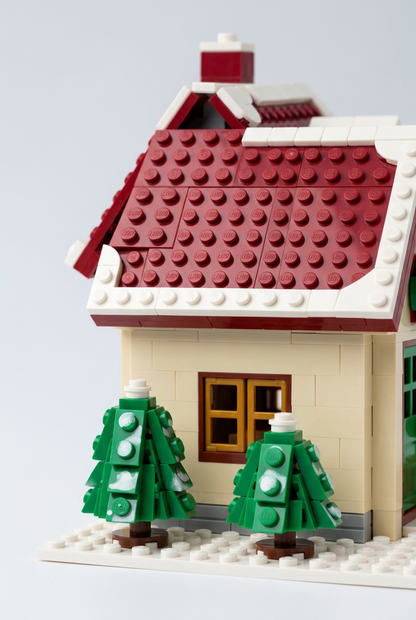 Snowfall Cottage Christmas Building Block Toy — A Red-Roofed Holiday House Concept with Wreath Doorway, Snowy Trees & Gift Details